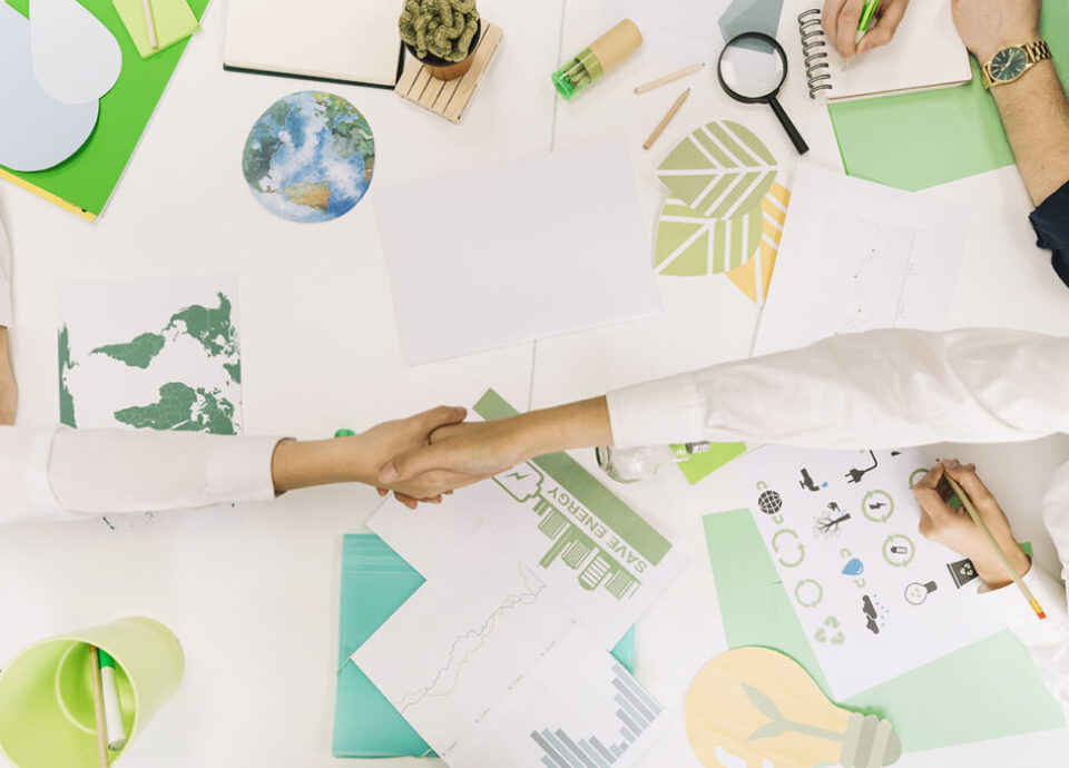high angle view two businesspeople shaking hands desk